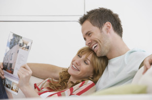 http://www.dreamstime.com/stock-images-cheerful-relaxed-couple-reading-brochure-sofa-side-view-young-image33838954